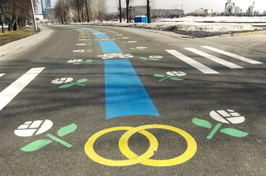 Wedding rings paint on a road. Cityscape background