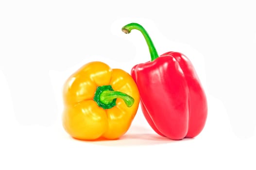Red and yellow peppers on white background.