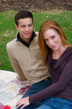 Young couple in an autumn forest picnic area
