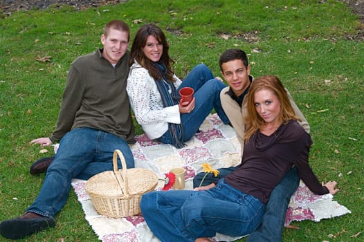 Young couple in an autumn forest picnic area
