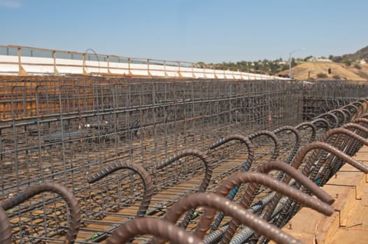 Highway bridge construction project showing rebar and wood framing