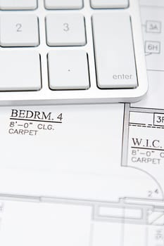 Modern architect&#039 s office with blueprint and computer keyboard