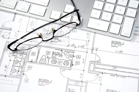 Modern architect&#039 s office with blueprint and computer keyboard