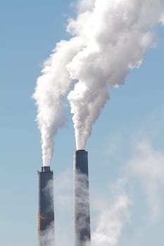 A tall smokestack spewing out dirty polluted smoke