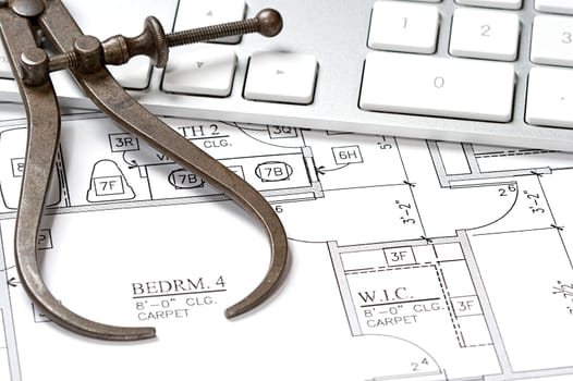 Modern arcbhitect&#039 s offic with blueprint and computer keyboard