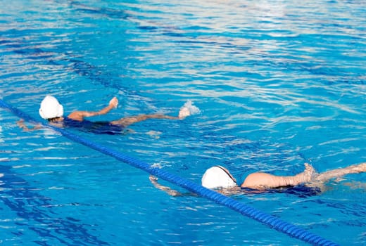 Water polo action and equipment in a swimming pool