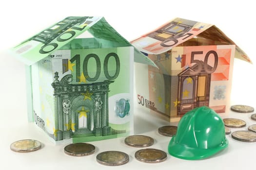 Construction helmet and euro bills against white background