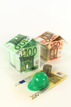Construction helmet and euro bills against white background