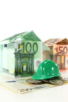 Construction helmet and euro bills against white background