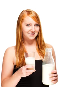 Young woman holding milk bottle and glass with milk on white background
