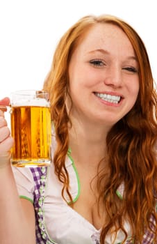 Happy redhead woman in dirndl holding beer on white background