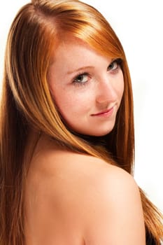 Young redhead woman looking over her shoulder on white background