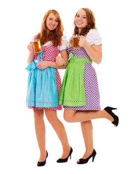 Two standing redhead women in dirndl and beer on white background
