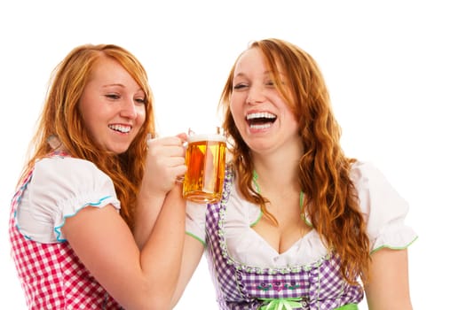 Two happy redhead women in dirndl celebrating on white background