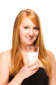 Young redhead woman with a glass of milk on white background