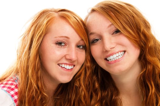 Two happy redhead women in dirndl on white background