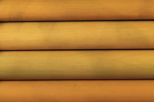 Close up of four horizontal smooth bamboo tubes