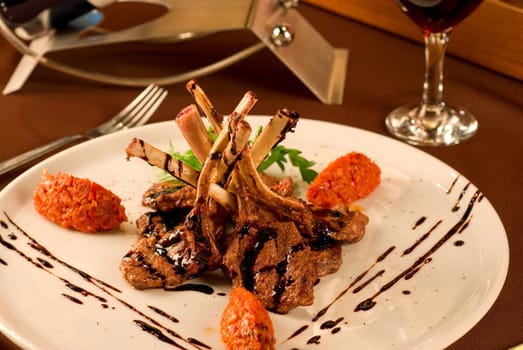 Roasted lamb chops with vegetables on decorated table