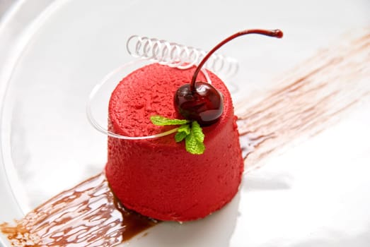 Tasty dessert of whipped cream, chocolate cherry, caramel and mint