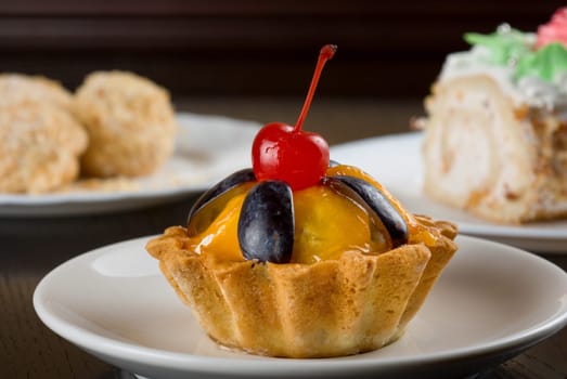 fresh baked cherry cupcake on a wooden table