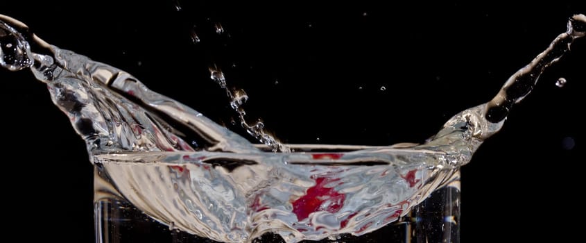 The motion of a slice of apple splashing into a glass of water