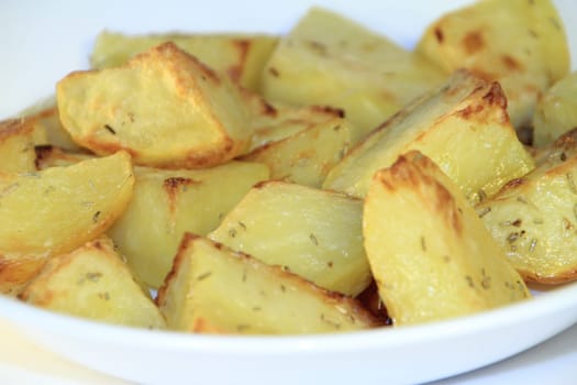 A close up of a dish of baked potatoes.
