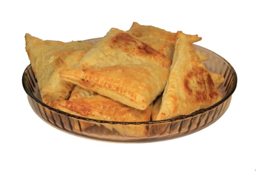 A plate of empanadas (or pasties) on a white background.