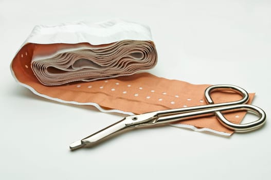Scissors and adhesive plasters