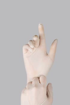 gloves on a hand on a grey background