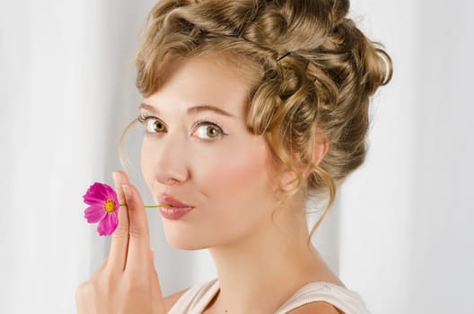 beauty woman closeup portrait with flower over grey background