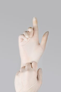 gloves on a hand on a grey background