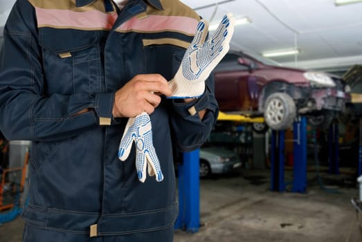 Auto mechanics closeup standing in his workshop