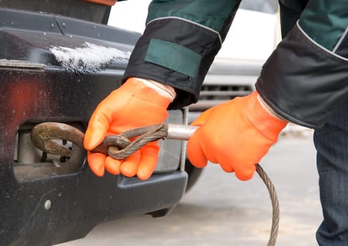 Man hands closeup with towing cable