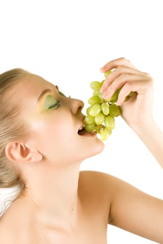 Pretty young woman with grape on the white background