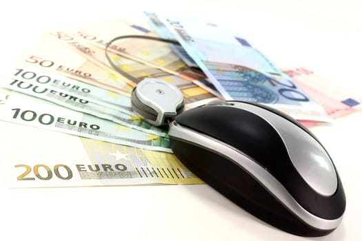 Computer mouse on euro bills