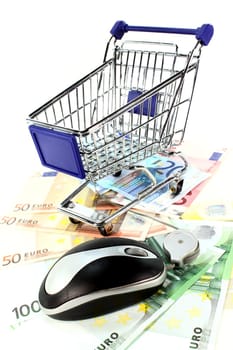 Shopping cart and euro bills against white background
