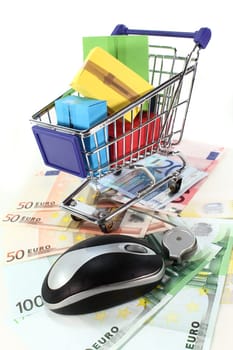 Shopping cart and euro bills against white background