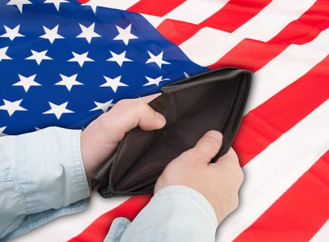 Financial Crisis in United States - Man&#039 s Hand With Empty Wallet and Flag of USA