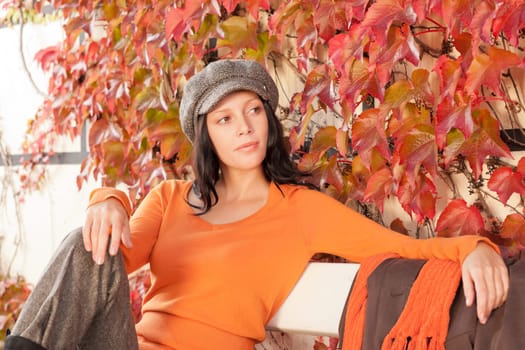 Autumn leaves park scenery young woman relax sitting on bench