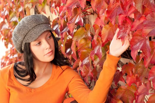 Autumn park scenery young woman relax touch leaf