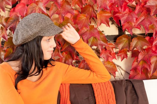 Autumn park scenery young woman relax on bench looking aside