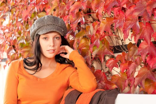 Autumn leaves park scenery young woman relax sitting on bench