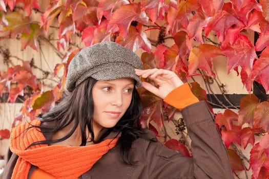 Autumn park scenery young woman relax on bench looking aside