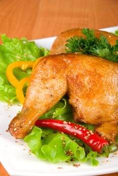 roasted chicken ham garnished with fresh green salad, pepper and greens