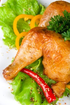 roasted chicken ham garnished with fresh green salad, pepper and greens