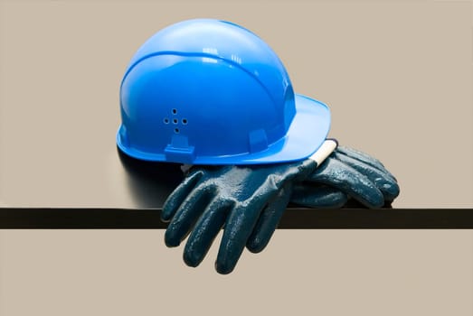 Blue hardhat and leather gloves