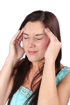 Pretty brunette girl holding her head because of a migraine headache