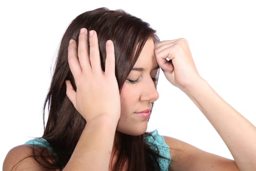 Pretty brunette girl holding her head because of a migraine headache