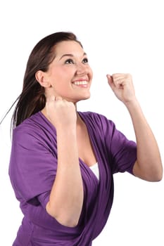 Happy and beautiful brunette woman with hands clenched and celebrating