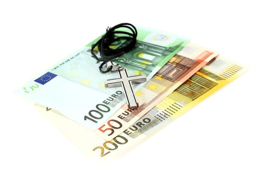 Euro note and cross against white background